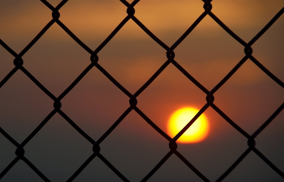 Sun behind bars